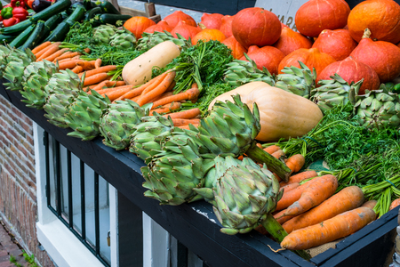 A selection of fresh vegetables on a market stallの写真素材
