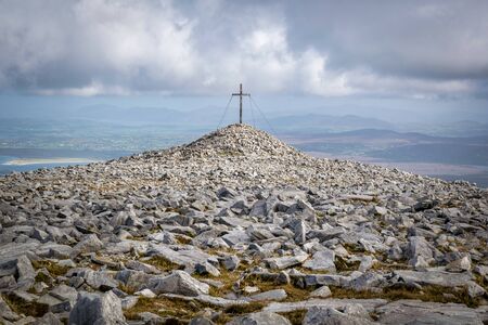 The rugged and rocky flat top of Muckish Mountain in Donegal Ierland.  In the distance is a cross...