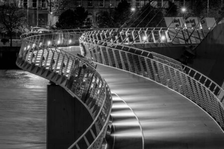 This is a black and white photograph of the Peace Bridge in Derry Northern Irelandの写真素材