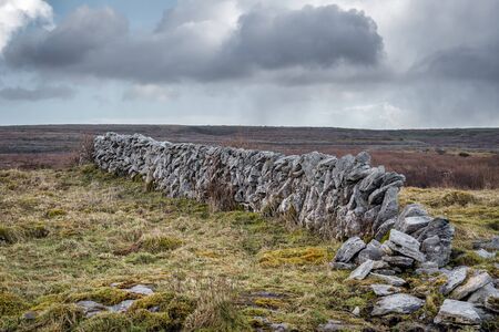Ruins of an old stone wall in the Burren of County Clare in Ireland