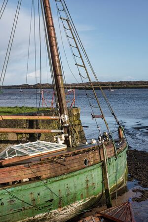 Two old wooden boats at low tide on the west coast of Ireland