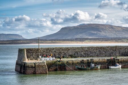 Mullaghmore Harbour wall and moored fishing boatsの写真素材