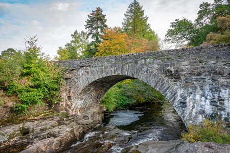 The Bridge of Dochart that traverses the Falls of Dochart in the village of Killin in the Scottish Highlandsの写真素材