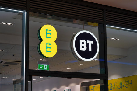 Edinburgh, Scotland- Nov 21, 2021:  The sign for the EE and BT Mobile store in Edinburgh.のeditorial素材