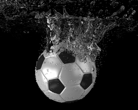 Soccer ball falling into waterの写真素材