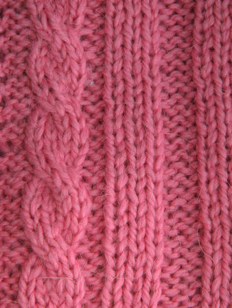 Pattern of pink knitting yarn. Facial and purl loops.