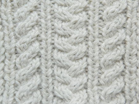 Knitted white pattern with the help of needles