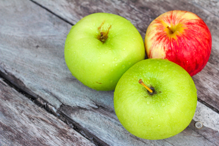 Three apples on the woodの写真素材