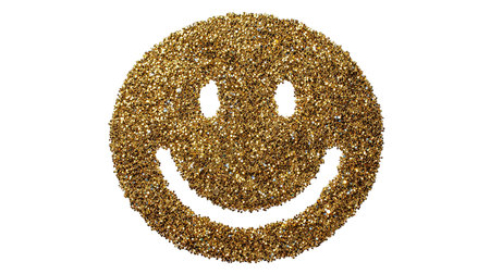 Smiley face made of golden sequins isolated on white background.の素材