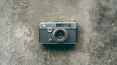 Vintage camera on cement background. Top view with copy space.の素材