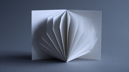 Open blank paper book on grey background. 3d render illustration.の素材