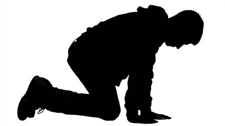 Silhouette of a man crouching on a white background.の素材