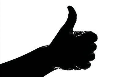 Silhouette of a hand showing thumbs up on a white backgroundの素材