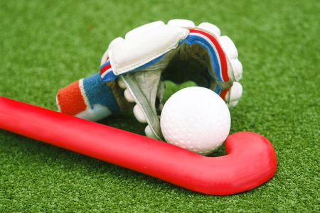 Glove with a red stick on green grassの写真素材