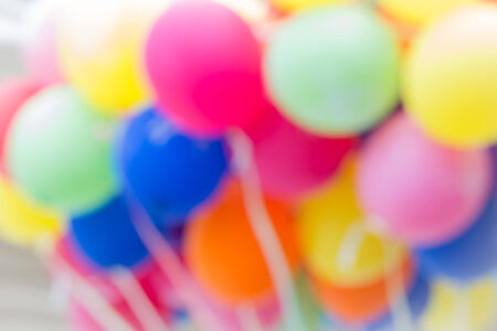 Multi colored toy balloons blurred backgroundの写真素材