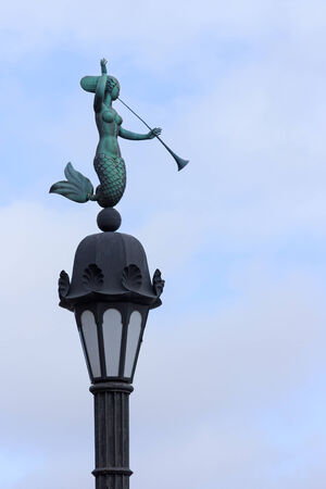 Water nymph with trumpet street-lamp, blue sky background, Saint Petersburg, Russiaの写真素材