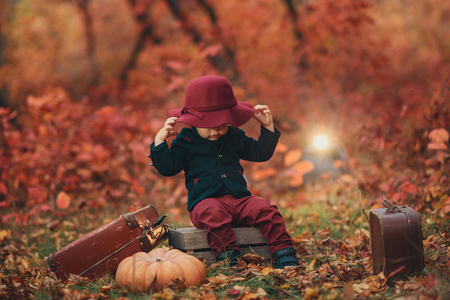 Little boy with suit case on railway out door. Travel conceptの写真素材