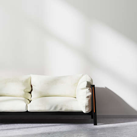 Close up of white sofa with white wall and concrete floor, modern interior background, 3d renderingの写真素材