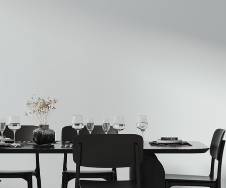 A beautiful dining table setted with cutlery, plates, glasses and decor, black furniture and empty white wall, 3d renderingの写真素材