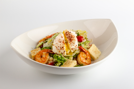 Caesar salad with shrimps and egg Pashotの写真素材