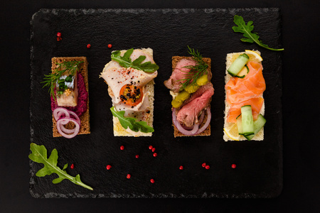 Assorted sandwiches with different fillings, ham and vegetables.の写真素材