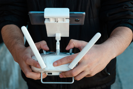 Guy controls drone with remote control, Close-up.