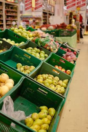 Bunch of red and green apples on boxes in supermarket.の写真素材