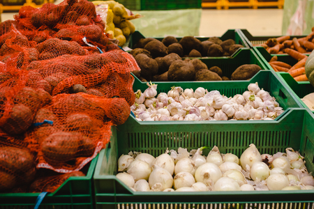 Assortment of vegetables at supermarket, shelves with variety vitamin products in fruit and vegetables department in the supermarketの写真素材