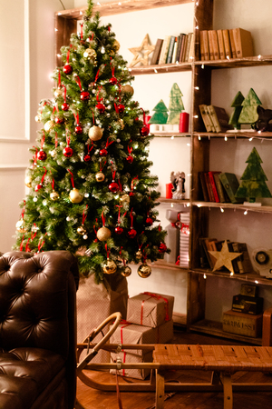 gift boxes under the Christmas tree. Colorful brown, golden Gift boxes with ribbon bow present on holiday.の写真素材