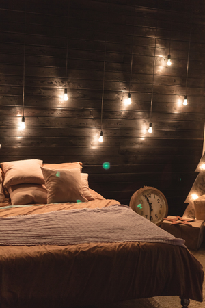Scandinavian style bedroom interior under Christmas. Textural wooden bed in the style of New Year's Rustic decoratedの写真素材