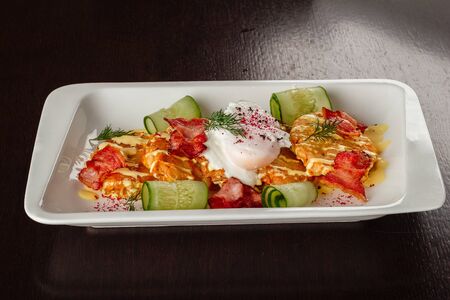Potato rosti pancakes, poached egg and bacon on top