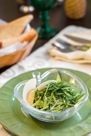 Spinach salad with fresh cucumbers,microgreen and quail eggs.Plate with tasty vegetable saladの写真素材