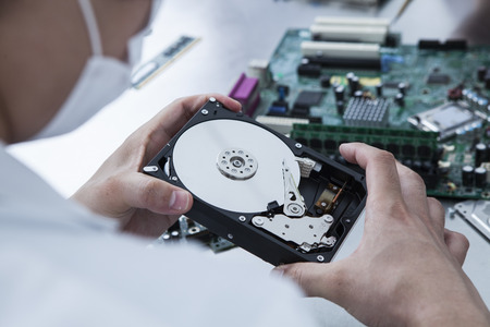 The hands of men with the parts of dismantling the personal computer