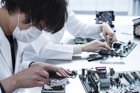 Men and women in dismantling the personal computer