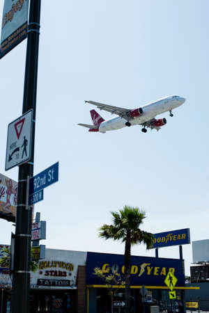 Airplane flying over the townのeditorial素材