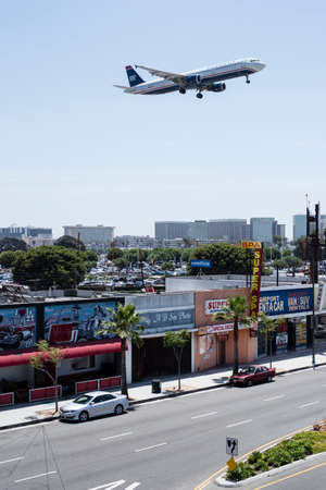 Airplane flying above the townのeditorial素材