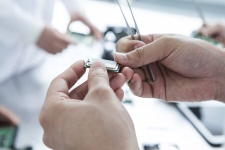 The hands of the engineers with the chipの写真素材