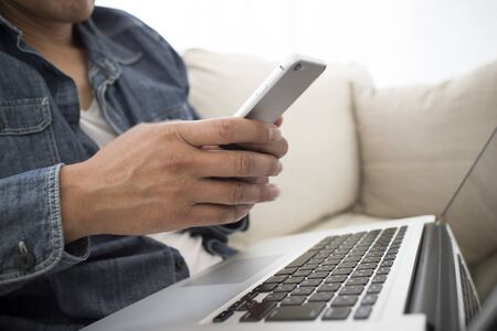 Men put the computer on top of the kneeの写真素材