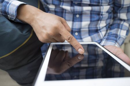 Men who will have to cushion use a tabletの写真素材