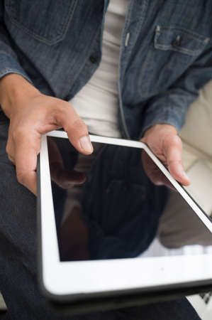 Closeup of male hands that use the tabletの写真素材