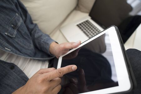The hands of men that use the tablet