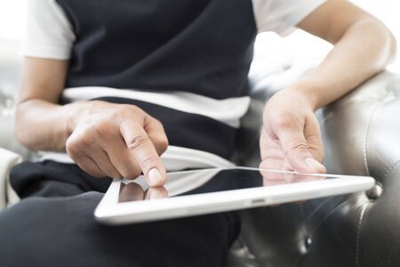 closeup of a young man using a tablet computer