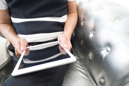 closeup of a young man using a tablet computer