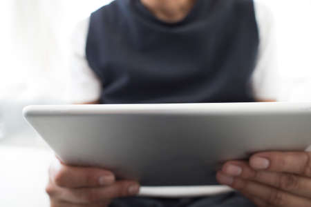 closeup of a young man using a tablet computer