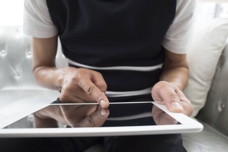 closeup of a young man using a tablet computer