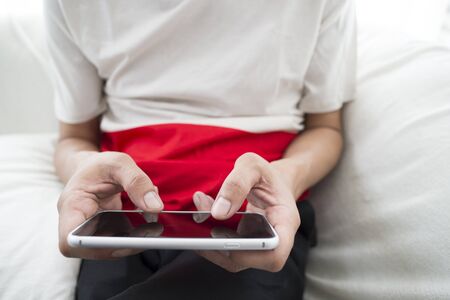 lose up of a man using mobile smart phoneの写真素材