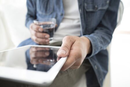 close up hands multitasking man using tablet, laptop and cellhpone connecting wifiの写真素材