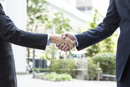 Close up of businessmen shaking handsの写真素材