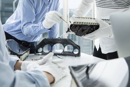 Money and financial planning, young hispanic self-employed woman checking bills and doing budget with calculator, computer and papers in fashion design studioの写真素材