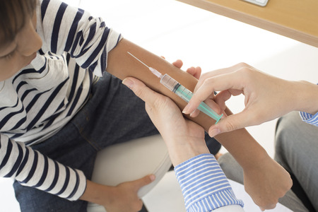 Doctor has hit the vaccination in the arm of the boy
